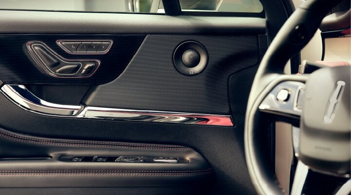 A Revel® audio speaker is shown in the driver's side door of a 2025 Lincoln Corsair® SUV. | Mark Ficken Lincoln in Charlotte NC