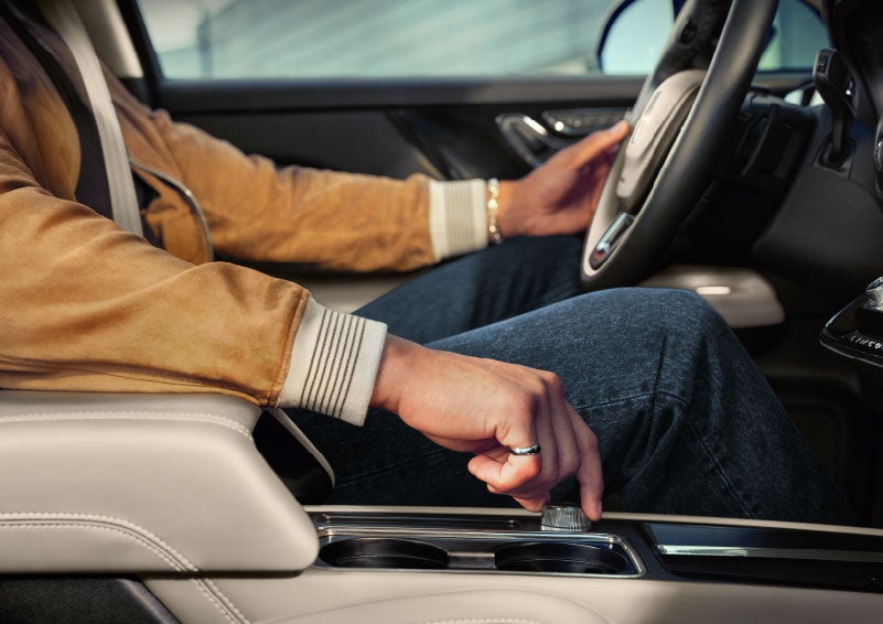 The driver of a 2024 Lincoln Corsair® SUV is shown selecting the drive mode. | Mark Ficken Lincoln in Charlotte NC