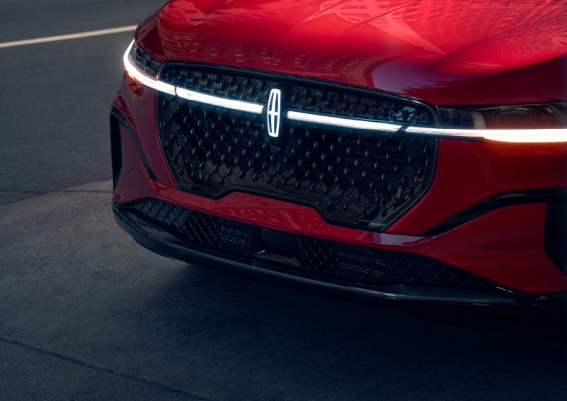 The available front LED light bar and center Lincoln Star logo glow at dusk. | Mark Ficken Lincoln in Charlotte NC