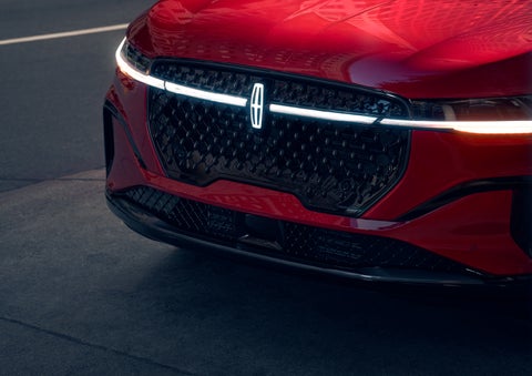 The available front LED light bar and center Lincoln Star logo glow at dusk. | Mark Ficken Lincoln in Charlotte NC