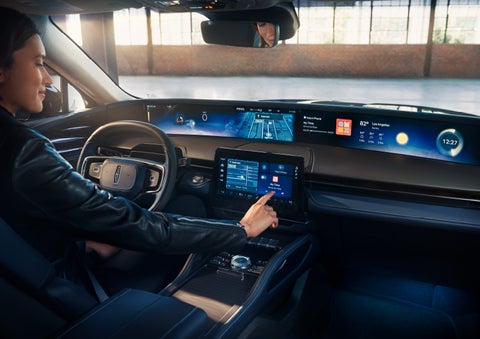 The driver of a 2025 Lincoln Nautilus® SUV interacts with the center touchscreen. | Mark Ficken Lincoln in Charlotte NC