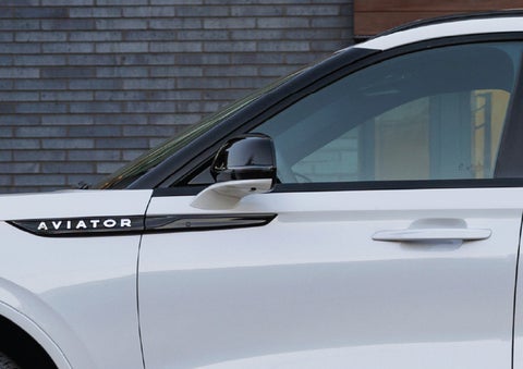 The driver’s side door and fender badging of a white 2026 Lincoln Aviator® SUV are showcased. | Mark Ficken Lincoln in Charlotte NC