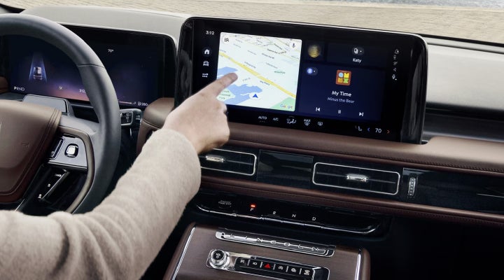 A person is tapping the center display touchscreen of a 2026 Lincoln Aviator® SUV. | Mark Ficken Lincoln in Charlotte NC