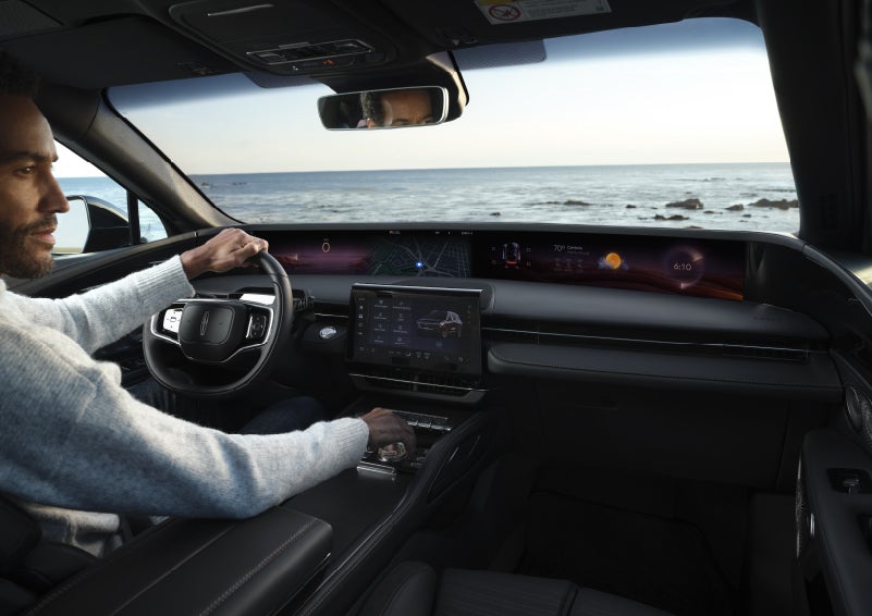 A driver of a parked 2026 Lincoln Nautilus® SUV takes a relaxing moment at a seaside overlook while inside his Nautilus. | Mark Ficken Lincoln in Charlotte NC
