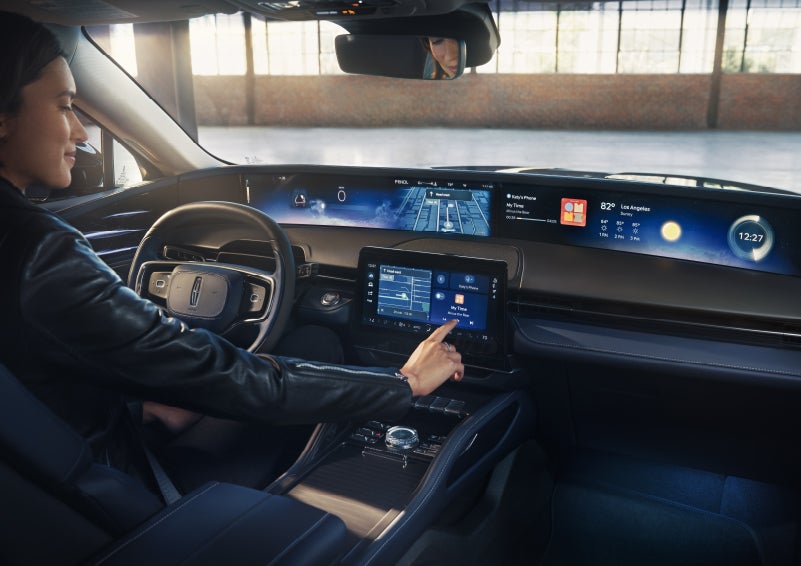 The driver of a 2026 Lincoln Nautilus® SUV interacts with the center touchscreen. | Mark Ficken Lincoln in Charlotte NC